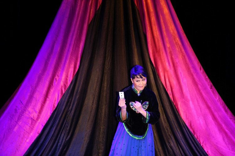 Chinese Canadian magician Juliana Chen performs card magic in Tigerpalast Variete in Frankfurt, Germany, on Feb. 09, 2014. (Xinhua/Luo Huanhuan)
